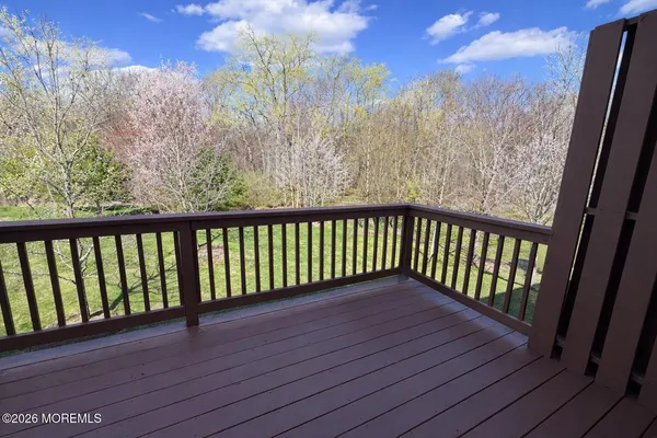 a view of a balcony with wooden floor