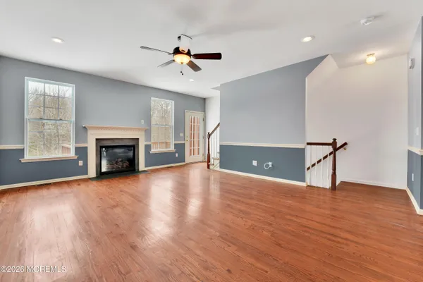 a view of an empty room with a fireplace and a window