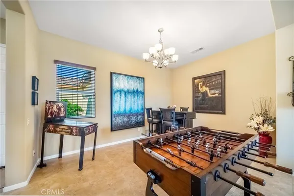 a living room with furniture a dining table and a fireplace