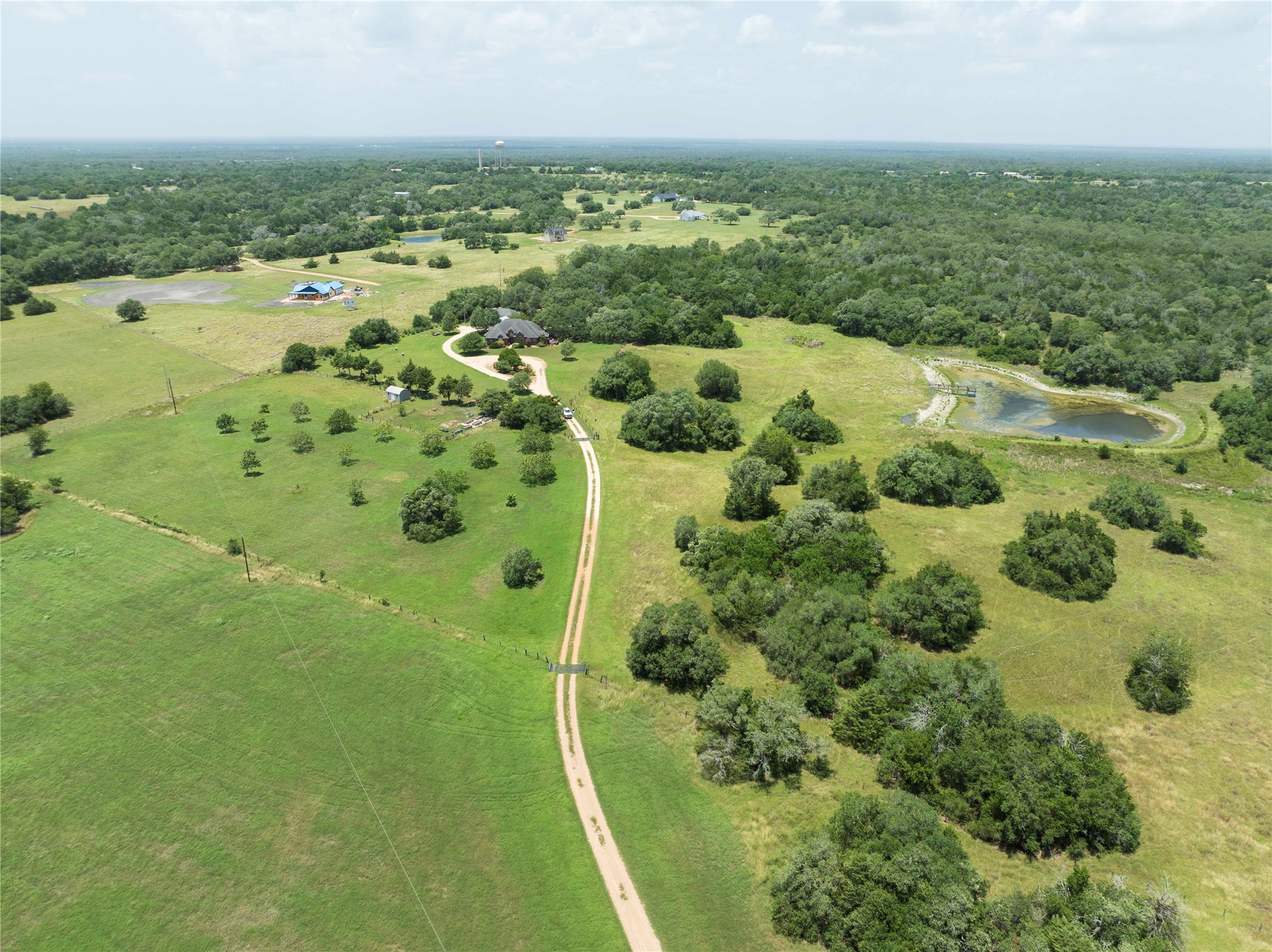 900 Schulze Road Muldoon, TX 78949 - Photo 1 of 44 an aerial view of residential houses with outdoor space and trees