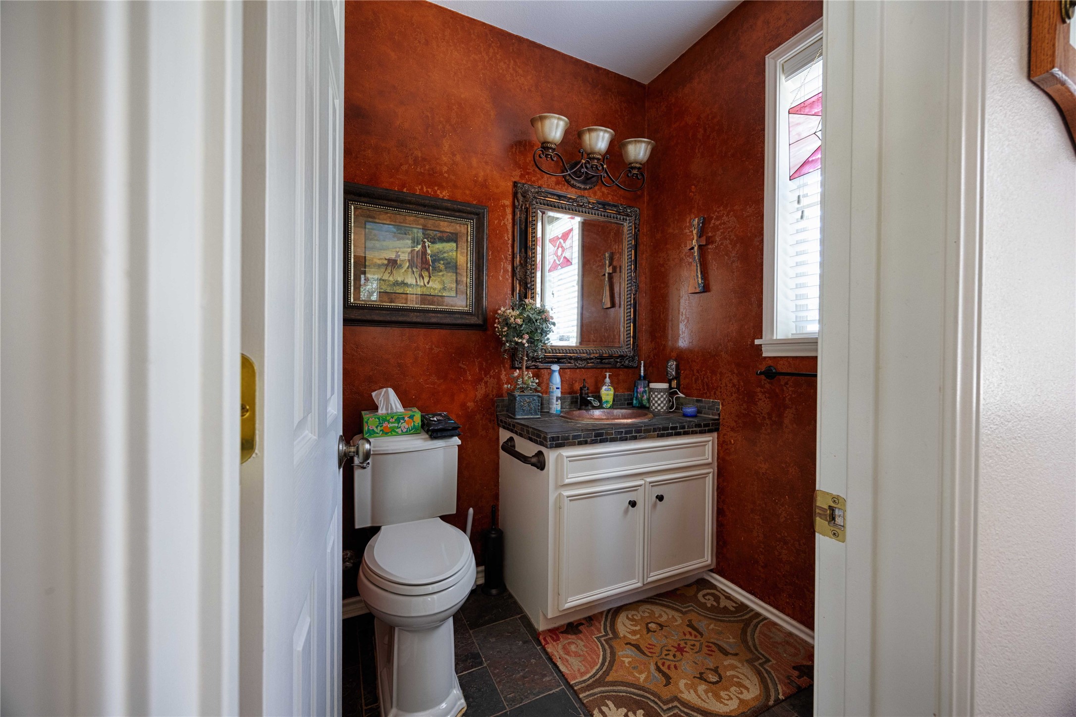 900 Schulze Road Muldoon, TX 78949 - Photo 18 of 44 a bathroom with a toilet a sink and a mirror