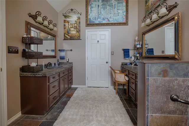 a kitchen with stainless steel appliances granite countertop a stove and cabinets
