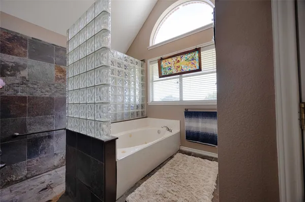 a patio with a table and chairs and potted plants