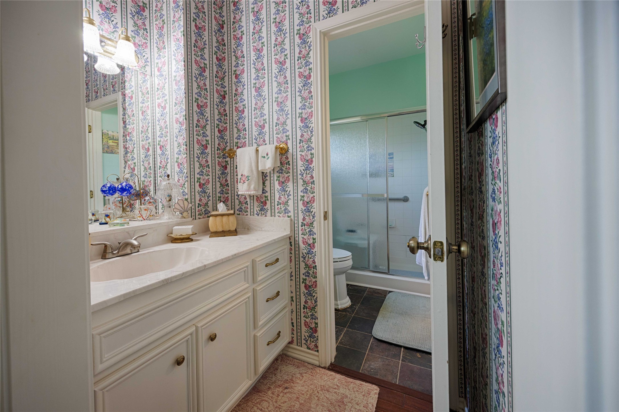 900 Schulze Road Muldoon, TX 78949 - Photo 26 of 47 a bathroom with a double vanity sink toilet and shower