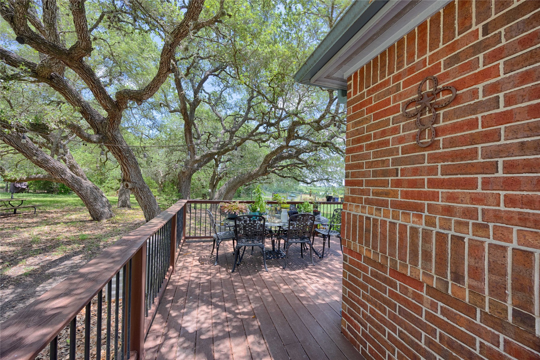 900 Schulze Road Muldoon, TX 78949 - Photo 28 of 47 a view of a patio with table and chairs and wooden floor