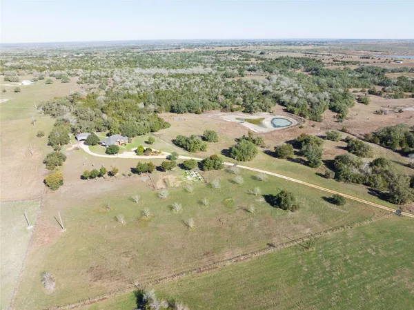 an aerial view of a residential houses with outdoor space