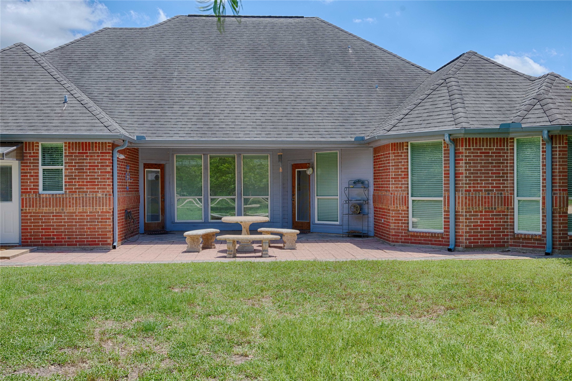900 Schulze Road Muldoon, TX 78949 - Photo 31 of 47 a patio with a table and chairs and potted plants
