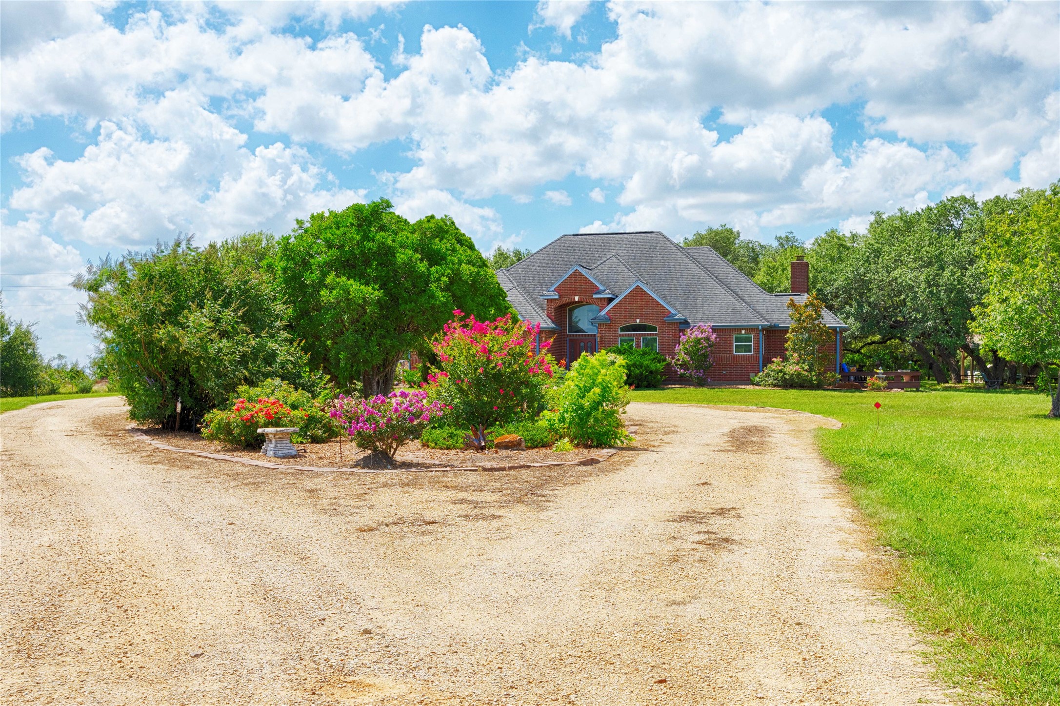 900 Schulze Road Muldoon, TX 78949 - Photo 7 of 47 a view of a house with a big yard and potted plants