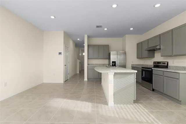a kitchen with a sink stainless steel appliances and cabinets