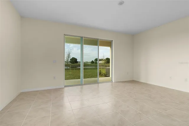 a view of an empty room with glass door