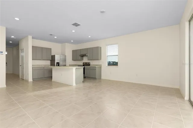 a view of kitchen with refrigerator sink and cabinets
