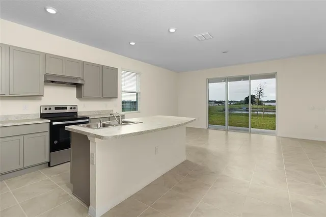a kitchen with a sink stove and cabinets