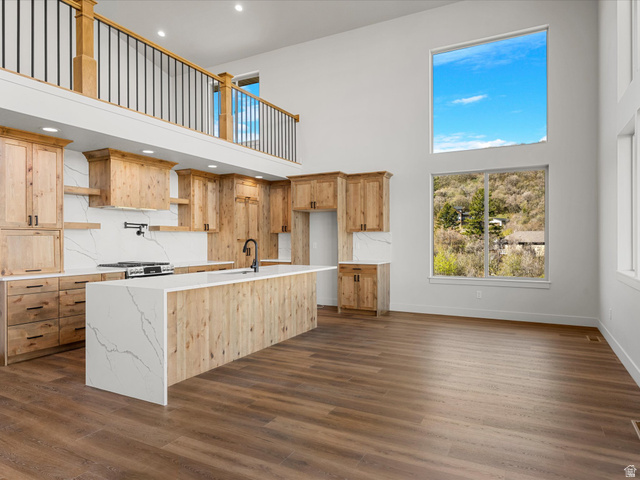 1159 North Broad Hollow Road Garden City, UT 84028 - Photo 11 of 55 Open-concept kitchen and living area featuring a two-story ceiling and wood-finish flooring