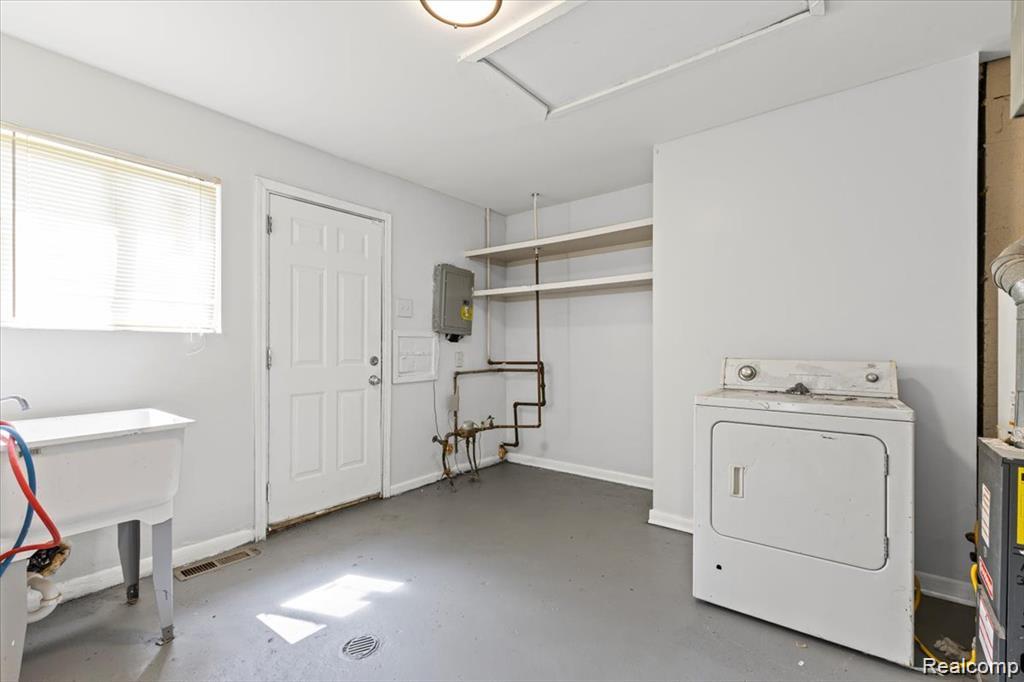 3930 Bayhan Street Inkster, MI 48141 - Photo 8 of 14 Utility space with a utility sink, white paneled door, and overhead shelving