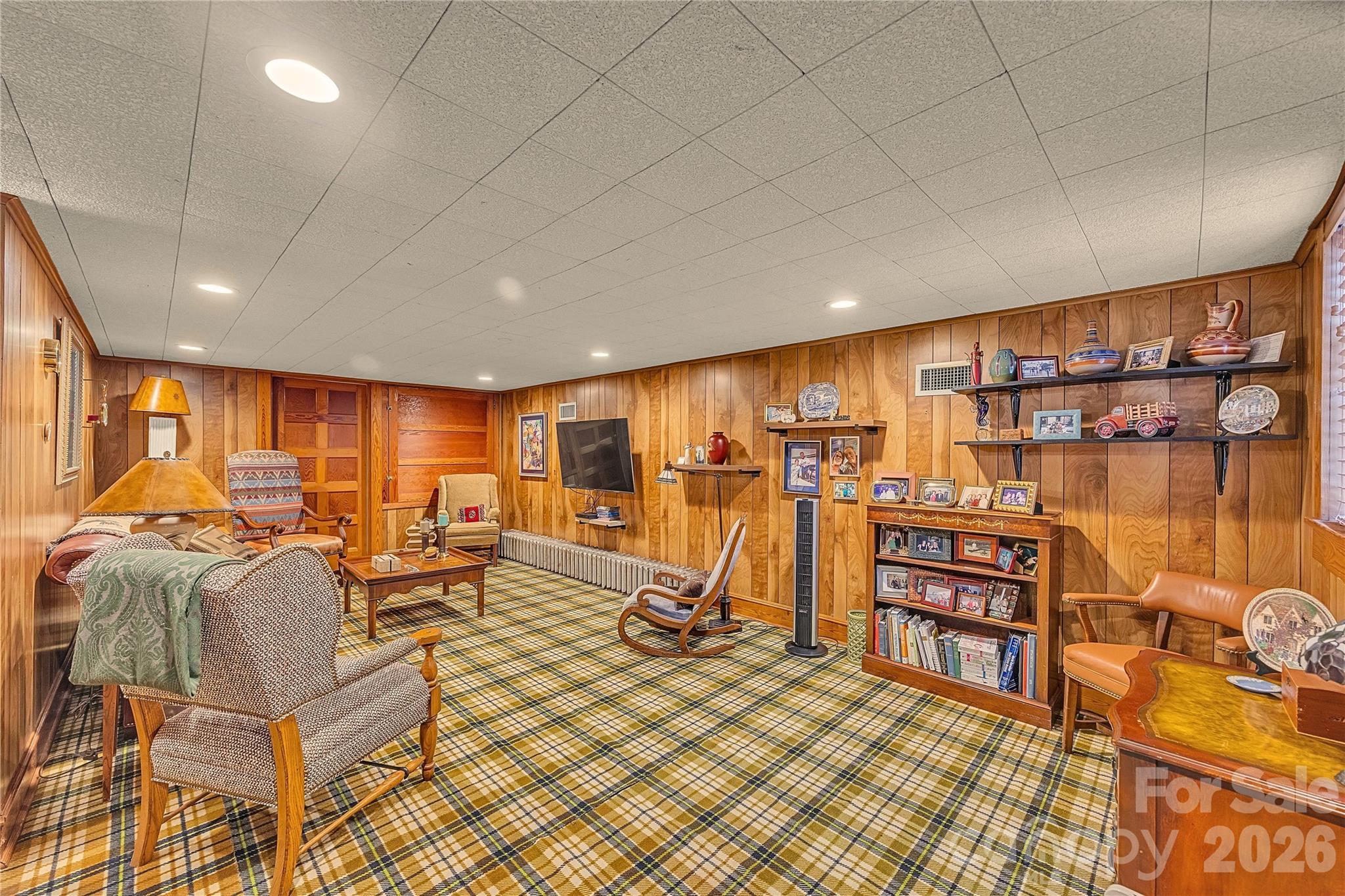 5510 South Main Street Salisbury, NC 28147 - Photo 26 of 43 a living room with furniture a rug and a flat screen tv