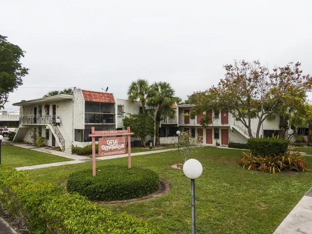 a backyard of a house with yard table and chairs