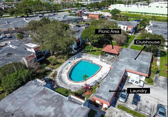 an aerial view of a house with a yard and lake view