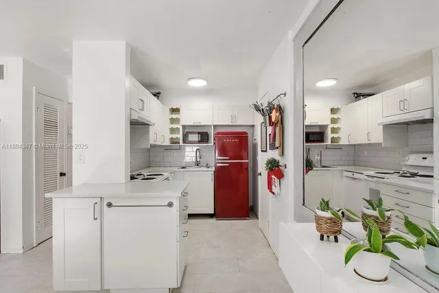 a kitchen with stainless steel appliances granite countertop a refrigerator and a stove
