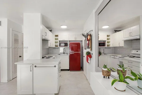 a kitchen with stainless steel appliances granite countertop a refrigerator and a stove