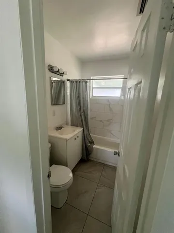 a bathroom with a toilet and shower