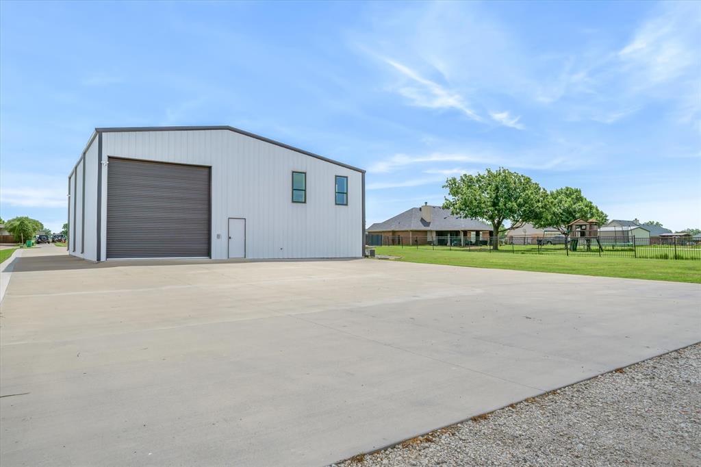 9346 Homestead Lane Forney, TX 75126 - Photo 35 of 39 The extended driveway and large concrete pad, 60 X 70, provides the space to drive and park trailers or heavy equipment behind the shop. In addition, there is a large gravel area, another 100 feet, for even more parking. This space could also be modified to be used as a sport court. An added feature is an outdoor 220/240 disconnect ready to be wired for your RV, air compressor, or welder.