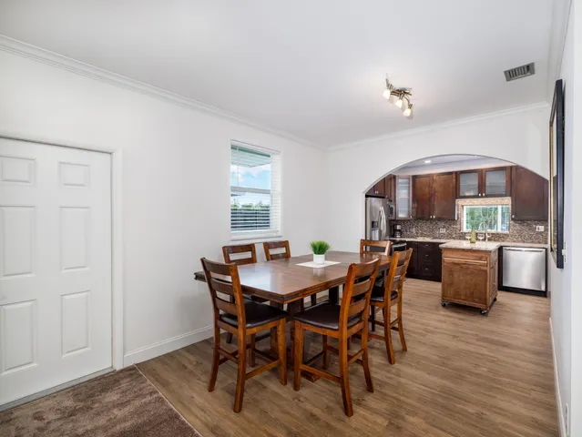 a view of a dining room with furniture and wooden floor