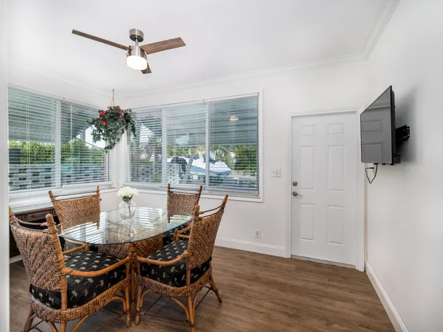 a dining room with furniture window and wooden floor
