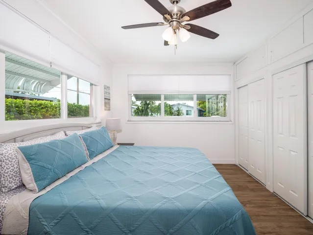 a bedroom with a large bed and a window