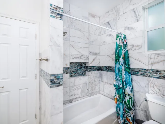 a bathroom with a bathtub and shower