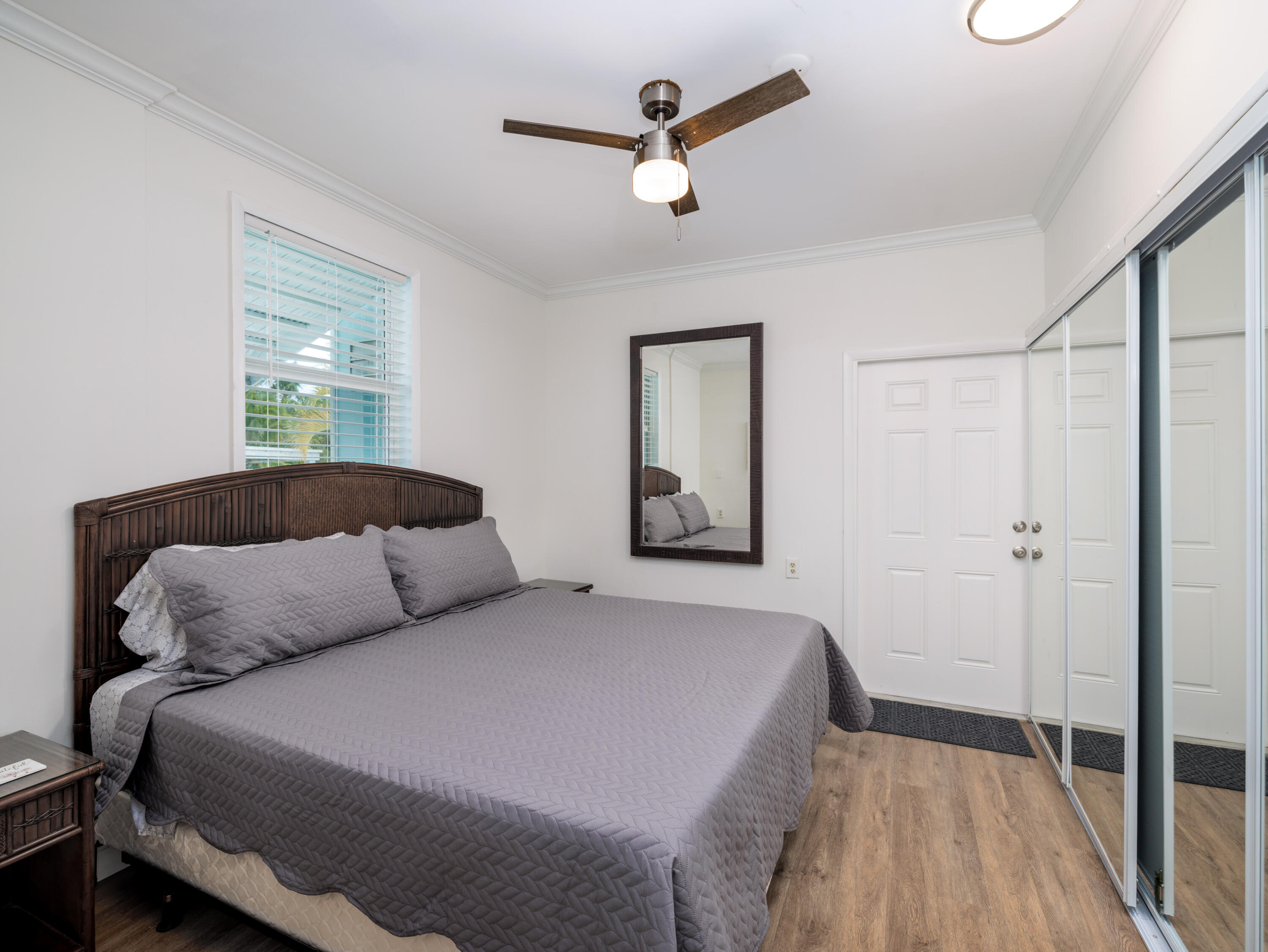 599 30th Street Marathon, FL 33050 - Photo 28 of 43 a bedroom with a large bed and a chandelier