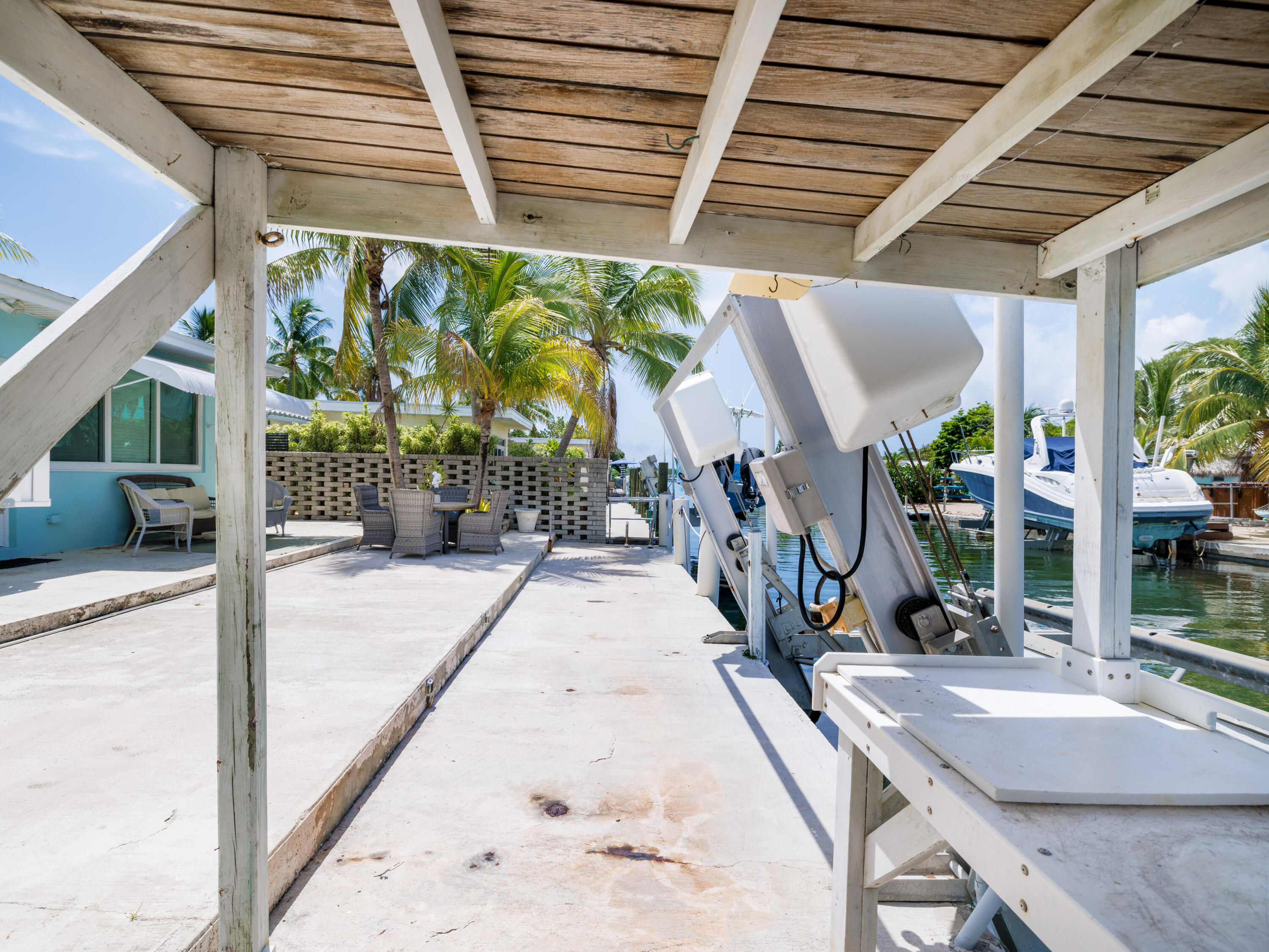 599 30th Street Marathon, FL 33050 - Photo 31 of 43 a view of a patio with table and chairs potted plants with wooden floor