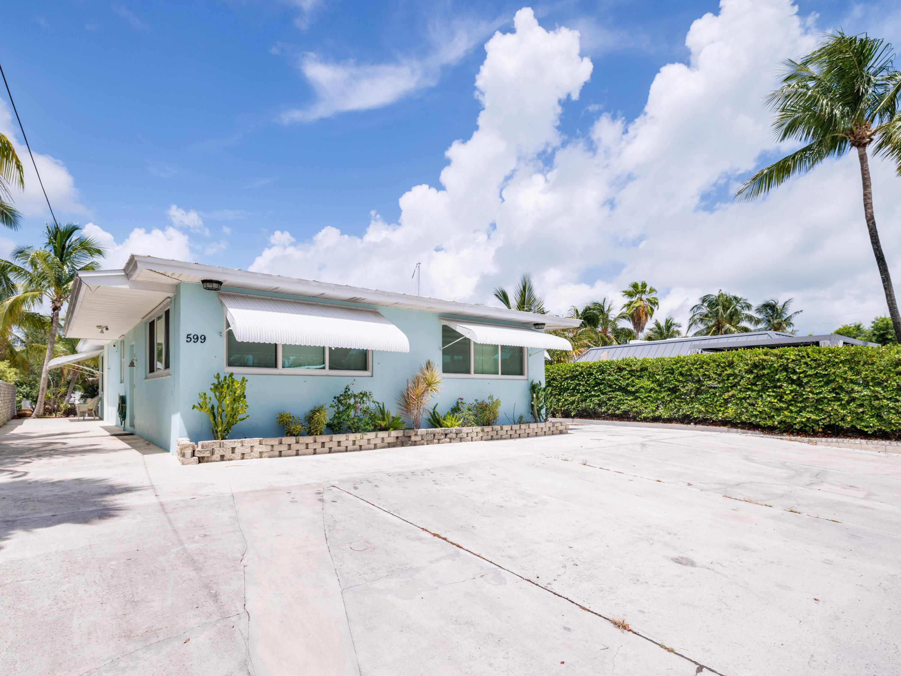599 30th Street Marathon, FL 33050 - Photo 40 of 43 a front view of a house with a yard and potted plants