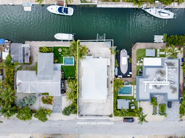 an aerial view of a house with a yard basket ball court and outdoor seating