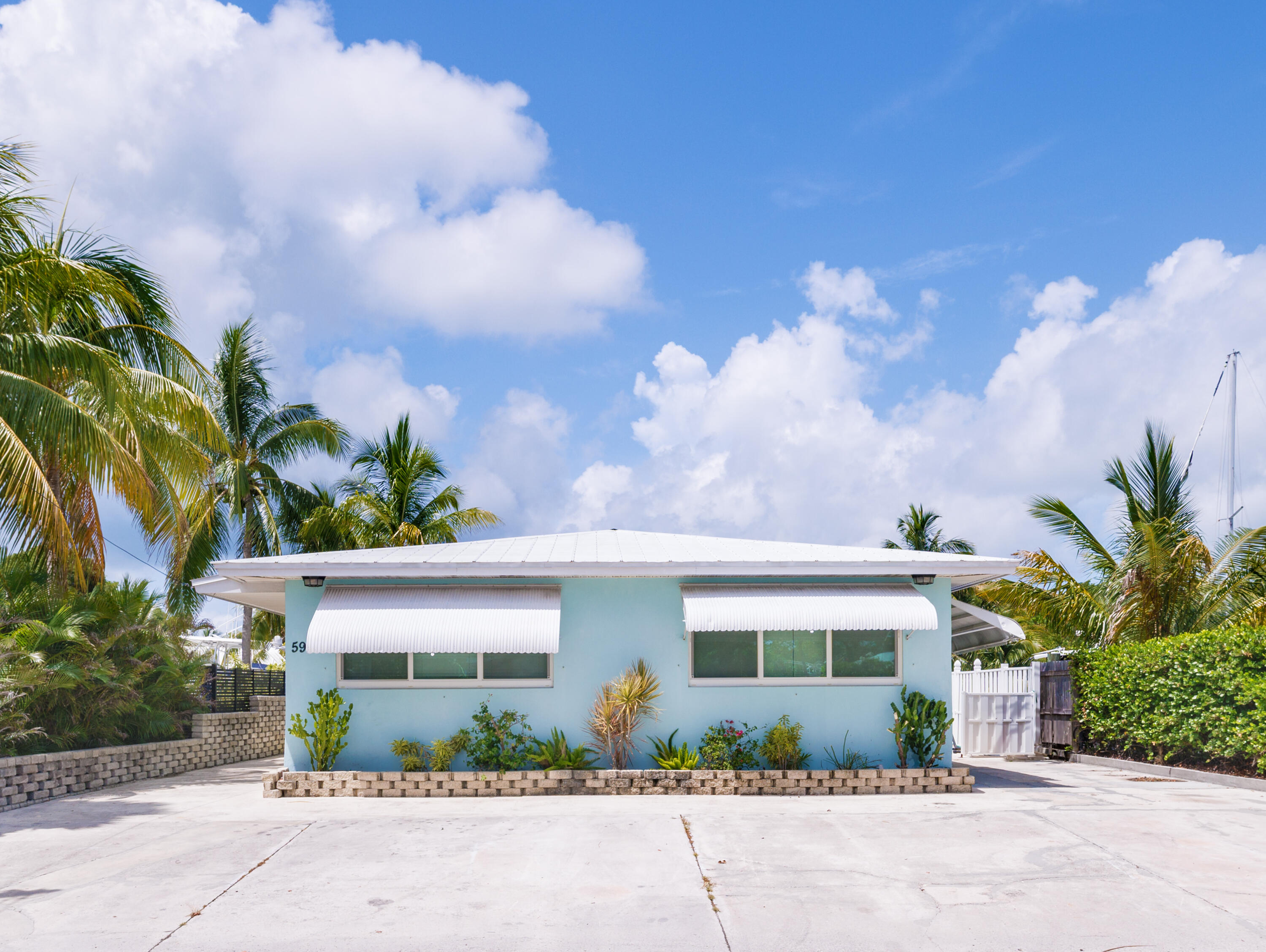 599 30th Street Marathon, FL 33050 - Photo 6 of 43 a front view of a house with a yard and potted plants
