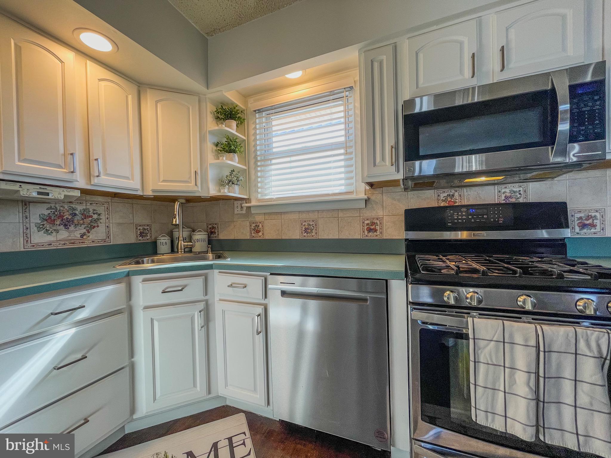 3445 Fitler Street Philadelphia, PA 19114 - Photo 12 of 32 a kitchen with white cabinets stainless steel appliances and a sink