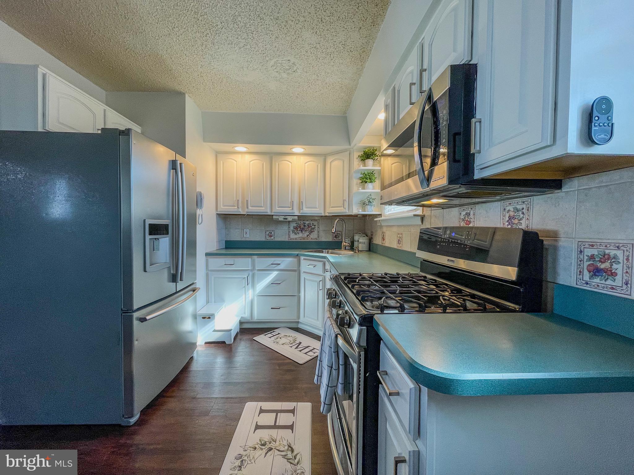 3445 Fitler Street Philadelphia, PA 19114 - Photo 10 of 32 a kitchen with stainless steel appliances granite countertop a refrigerator a stove and a sink