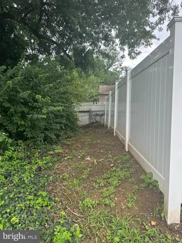 a backyard of a house with lots of green space and outdoor seating