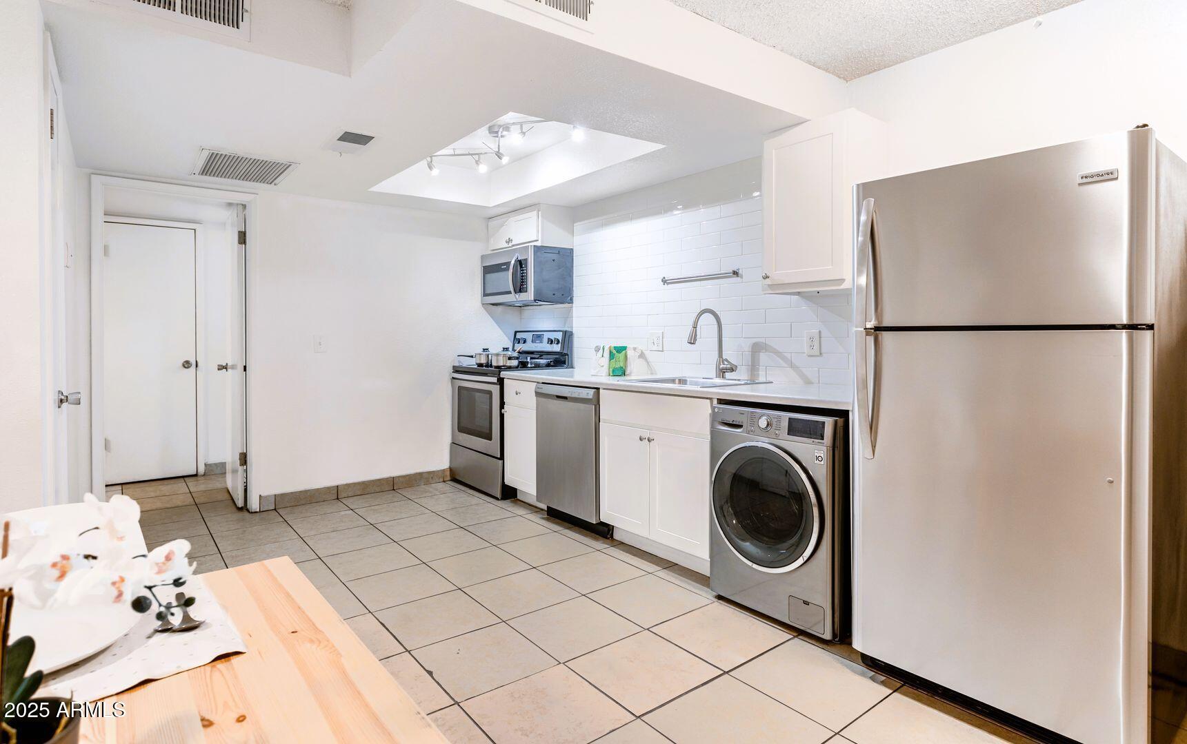 1623 West Missouri Avenue, Unit 1 Phoenix, AZ 85015 - Photo 2 of 12 a utility room with dryer and washer