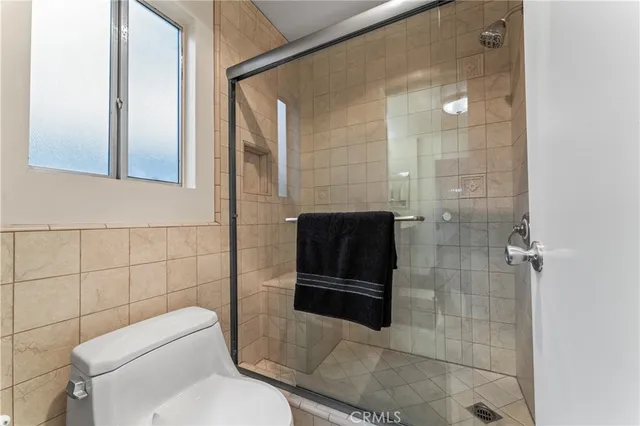 a bathroom with a toilet and a shower