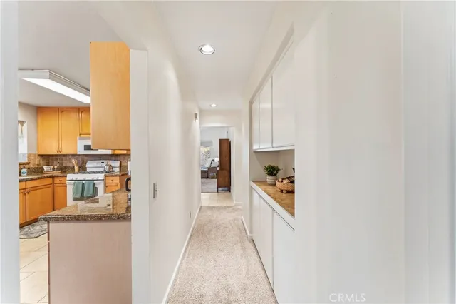 a hallway with a sink and a refrigerator