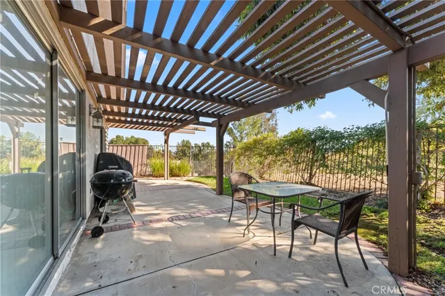 a view of a porch with furniture and a yard