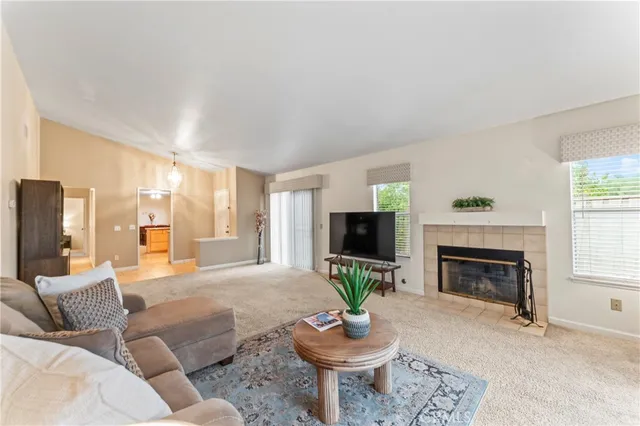 a living room with furniture a fireplace and a flat screen tv