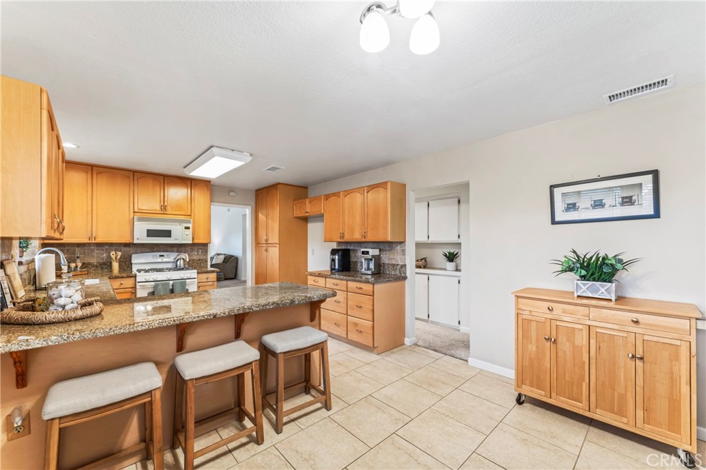 14720 Marymount Street Moorpark, CA 93021 - Photo 4 of 22 a kitchen with white cabinets and sink