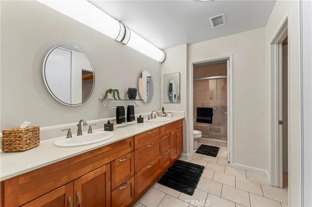 a large bathroom with a double vanity sink and a mirror