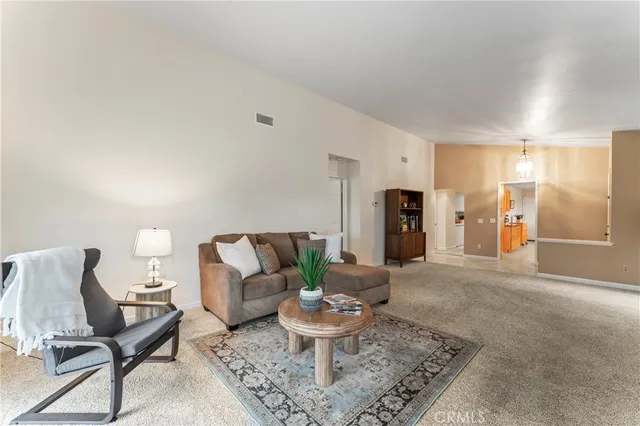 a living room with furniture and a potted plant