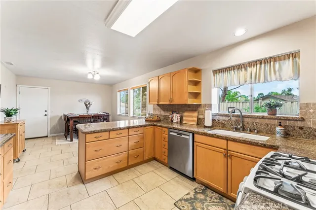 a kitchen with stainless steel appliances a stove sink and cabinets