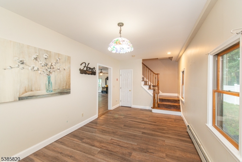 40 Castle Rock Road Lake Hopatcong, NJ 07849 - Photo 4 of 20 a view of a hallway with wooden floor and staircase