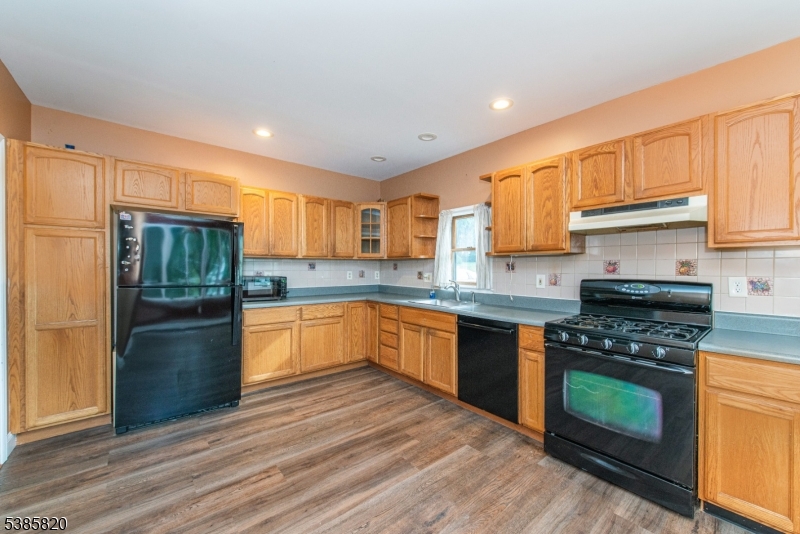 40 Castle Rock Road Lake Hopatcong, NJ 07849 - Photo 7 of 20 a kitchen with stainless steel appliances granite countertop a stove a sink dishwasher and a refrigerator
