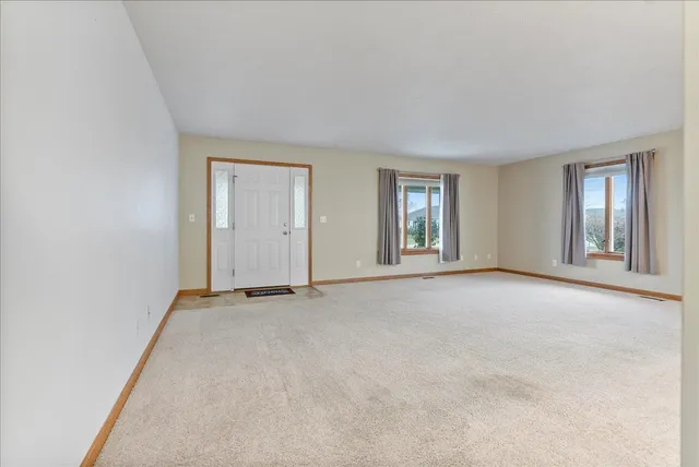 an empty room with windows and closet