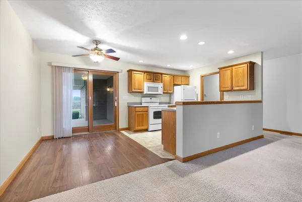 a view of a kitchen with a sink a refrigerator and a window